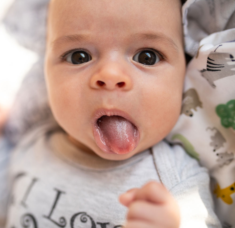 Baby sticking out tongue playfully