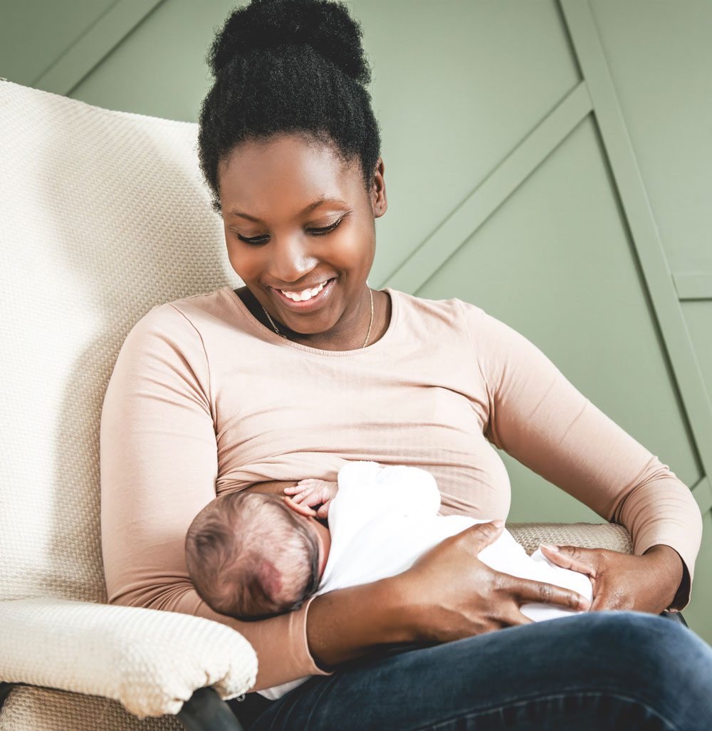 Woman sitting in chair holding baby