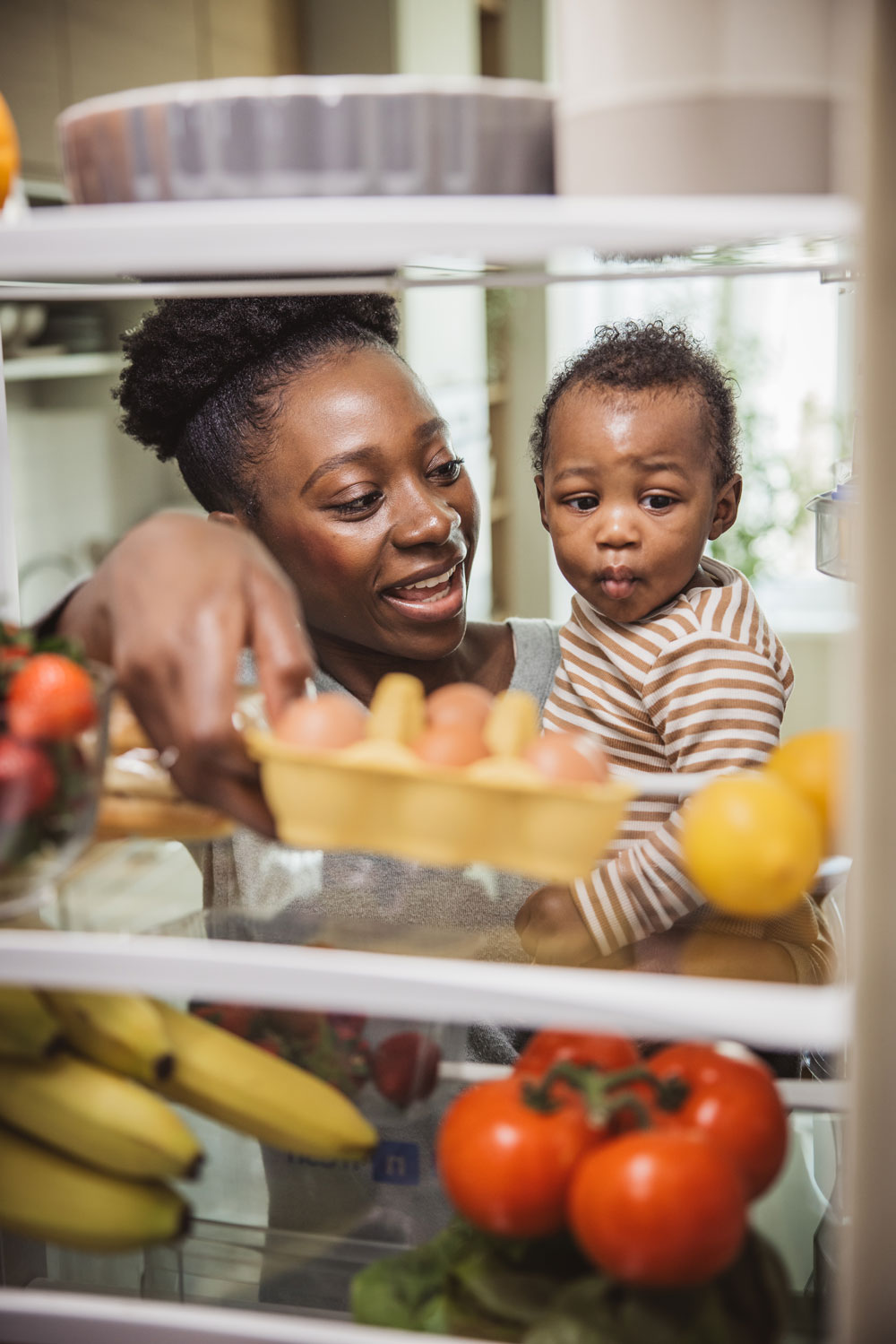woman and a child examine fresh fruit inside