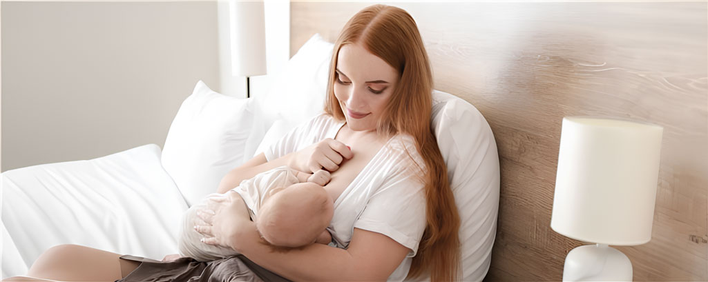 Mother breastfeeding her baby while sitting comfortably