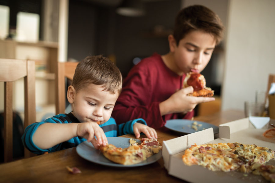 Two boys having pizza