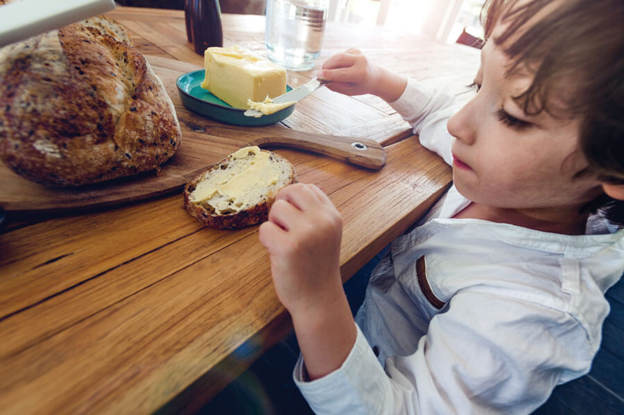 Kid Eating Bread Butter Image