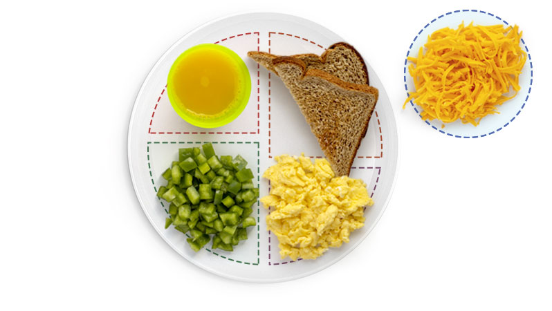 A young child eating breakfast, likely sitting at a table with a bowl or plate of food.