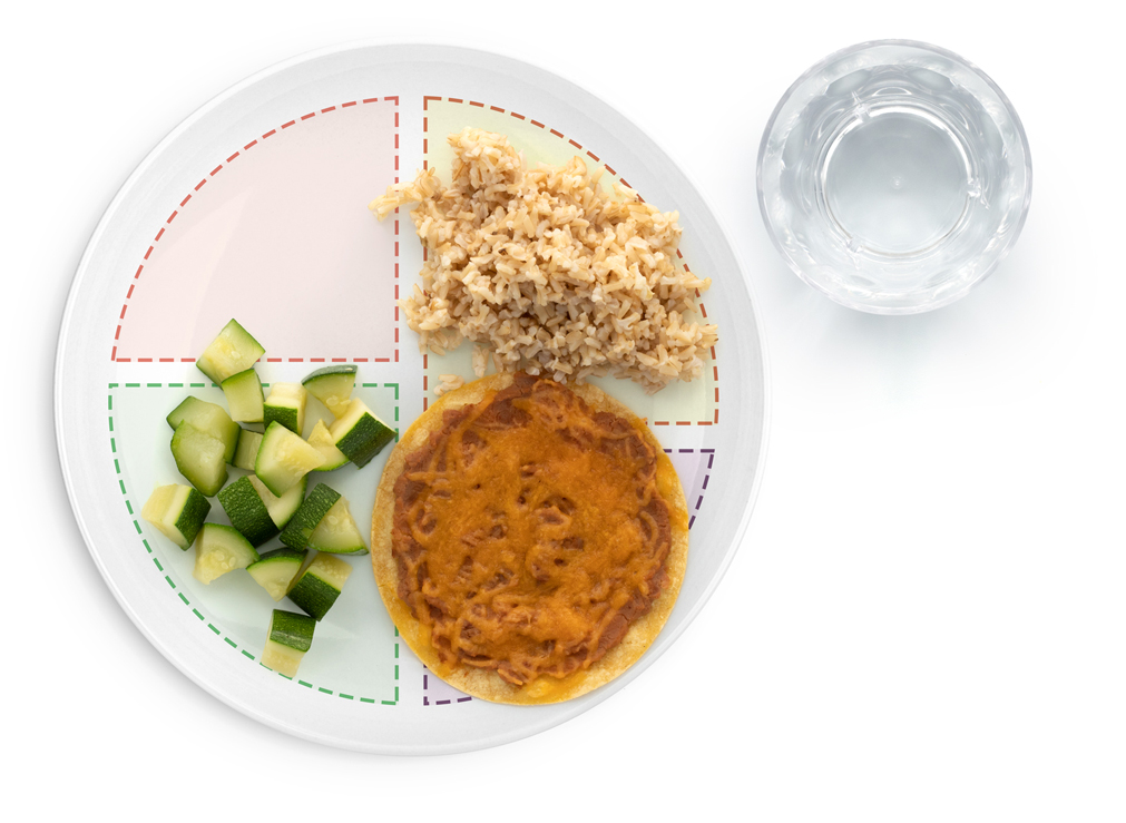 Section showing image of Bean Tostada, rice, and diced zucchini