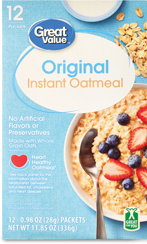 Oatmeal box with fruit-topped bowl and metal spoon.