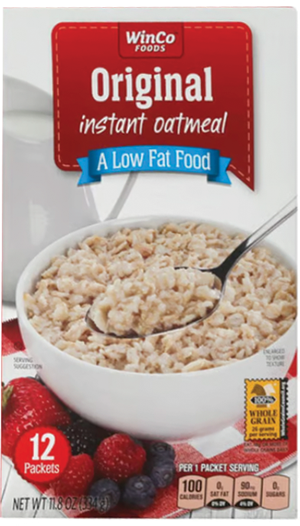 Bowl of oatmeal with spoon on cereal box.