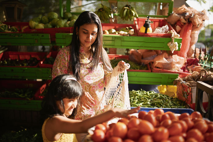 Mother and child shopping for vegetables