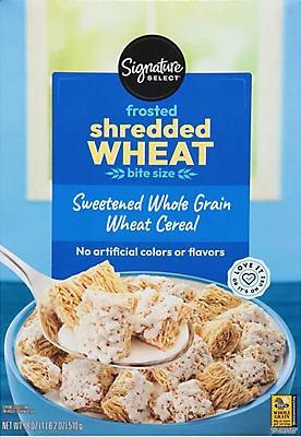 Bowl of frosted shredded wheat cereal with spoon.