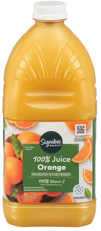 Orange juice bottle with green label and oranges.