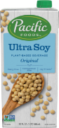 Soy milk carton with wooden spoon and soybeans.