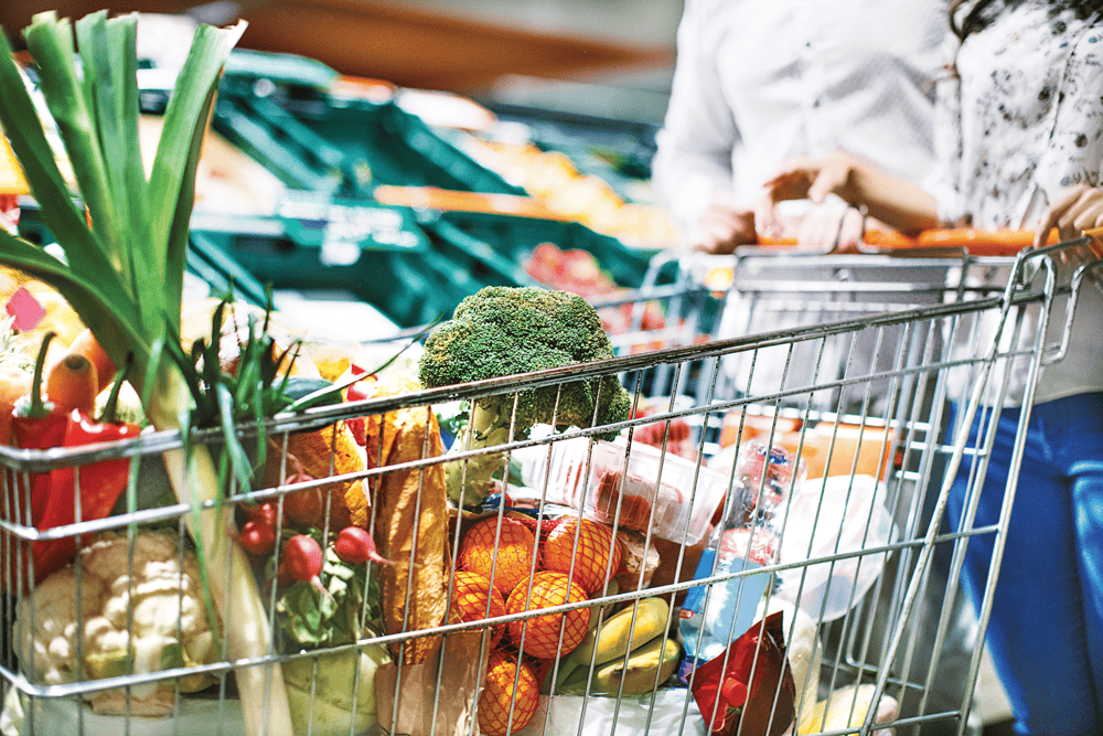 Shopping cart filled with fresh fruits and vegetables